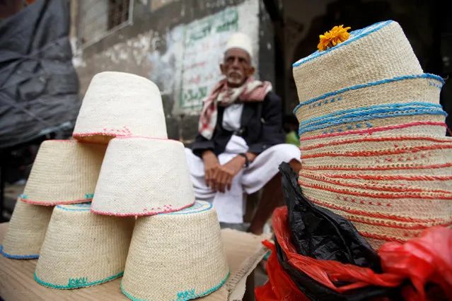 A vendor selling traditional hats waits for customers at the old quarter of the city of Sanaa, Yemen, July 24, 2016. (Photo by Mohamed al-Sayaghi/Reuters)