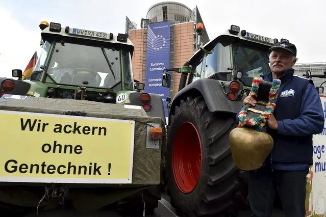 A farmer stands next to the European Commission headquarters as farmers and dairy farmers from all over Europe take part in a demonstration outside a European Union farm ministers' emergency meeting in Brussels, Belgium September 7, 2015. (Photo by Eric Vidal/Reuters)