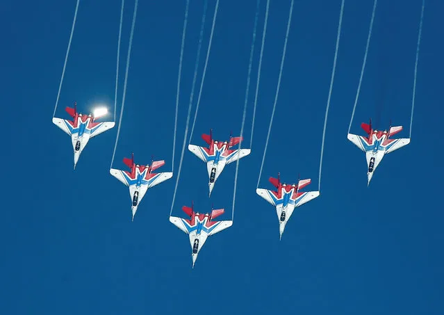 Mikoyan MiG-29 jet fighters of the Strizhi (Swifts) aerobatic team fly in formation during the International Army Games 2016, in Dubrovichi outside Ryazan, Russia, August 5, 2016. (Photo by Maxim Shemetov/Reuters)
