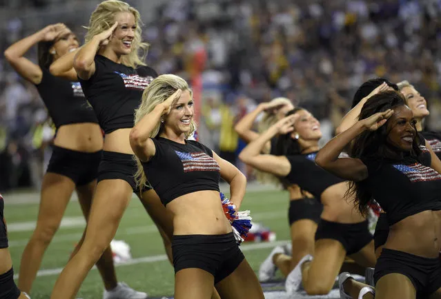 The Baltimore Ravens cheerleaders perform during the first half of an NFL football game against the Pittsburgh Steelers Thursday, September 11, 2014, in Baltimore. (Photo by Nick Wass/AP Photo)