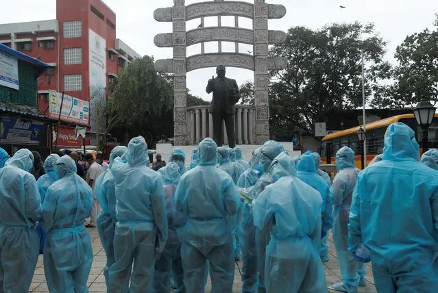 Healthcare workers stand in front of a statue of Babasaheb Ambedkar, founder of the Indian Constitution, before the start of a check-up camp for the coronavirus disease (COVID-19) in Mumbai, June 17, 2020. (Photo by Francis Mascarenhas/Reuters)