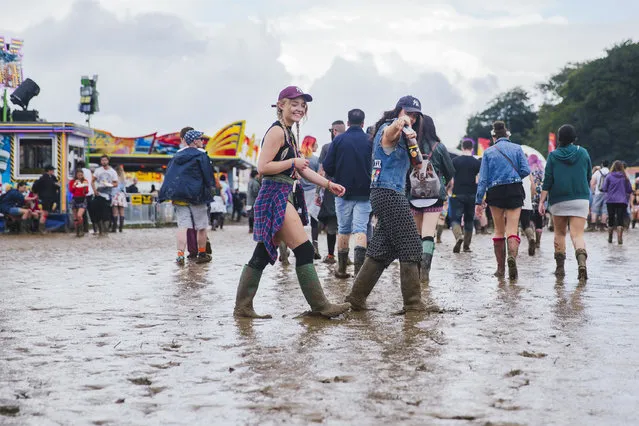 Festivalgoers walk in the mud at Leeds festival in Leeds, UK on August 29, 2016. (Photo by Andrew Benge/Redferns)