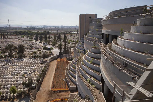 This Oct. 6, 2014, photo shows a new vertical part of the Yarkon cemetery outside of the city of Petah Tikva, Israel. With real estate at a premium, Israel is at the forefront of a global movement building vertical cemeteries in densely populated countries. The reality of relying on finite land resources to cope with the endless stream of the dying has brought about creative solutions. (AP Photo/Dan Balilty)