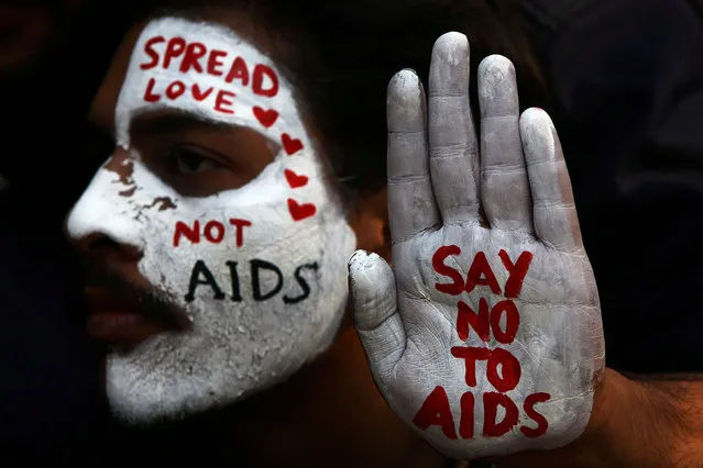 A student displays his face and hand painted with messages during an HIV/AIDS awareness campaign on the occasion of World AIDS Day in Chandigarh, India, December 1, 2017. (Photo by Ajay Verma/Reuters)