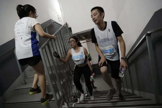 Exhausted participants walk up the steps as they compete in the China World Summit Wing Hotel Vertical Run held at the China World Trade Tower 3 in Beijing, Saturday, August 3, 2016. The race participants climbed 82 floors, covering a total of 2,041 steps, to the top of the 330-meter (1083-foot) tower located at Beijing's Central Business District. (Photo by Andy Wong/AP Photo)