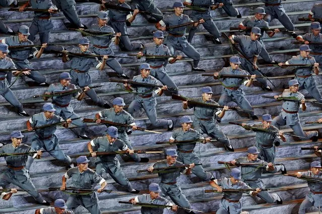 Actors dressed as Red Army soldiers perform at a gala show to mark the 70th anniversary of the end of World War Two, in Beijing, China, in this September 3, 2015 file photo. Bitterness is growing within China's armed forces to President Xi Jinping's decision to cut troop numbers by 300,000 and considerable effort will be needed to overcome opposition to the order, according to a source and commentaries in the military's newspaper. Photo by Kim Kyung-Hoon/Reuters)
