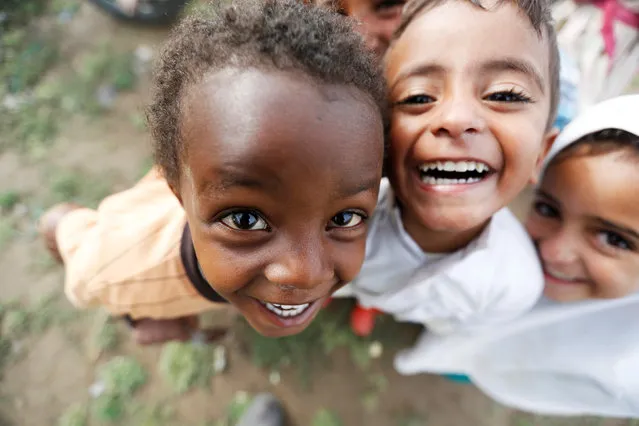 Children pose for a photo at a camp for internally displaced people near Sanaa, Yemen, August 10, 2016. (Photo by Khaled Abdullah/Reuters)