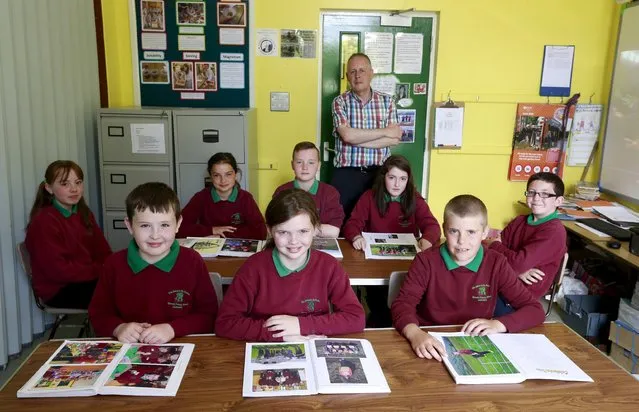 Primary 7 pupils from Glenaan Primary School in the Glens of Antrim pose for a group picture in their classroom with their teacher and school principal Mr. Close in Northern Ireland, June 22, 2015. (Photo by Cathal McNaughton/Reuters)
