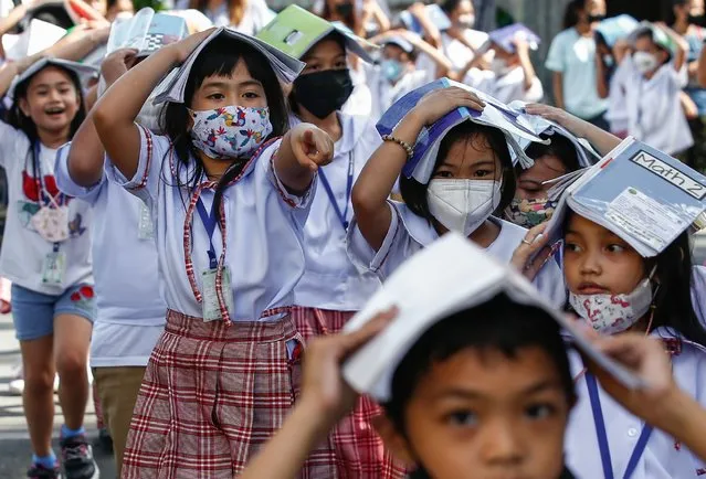 Students practice evacuation procedures during an earthquake drill at an elementary school in Quezon City, Metro Manila, Philippines, 10 November 2022. A nationwide earthquake drill is conducted every quarter of the year in the country to enhance disaster response among citizens to prevent mass casualties. (Photo by Rolex Dela Pena/EPA/EFE/Rex Features/Shutterstock)