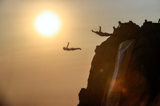 Divers take the plunge from the Quebrada cliff in the resort town of Acapulco, Guerrero, Mexico, 15 April 2025. The divers at La Quebrada, a 35-meter-high cliff in the Mexican port of Acapulco, southern Mexico, received the Guinness World Record certificate for five million head dives, the highest number of head dives in the world. (Photo by David Guzman/EPA)