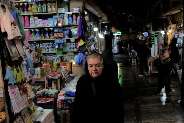 A woman walks through Tajrish bazaar in northern Tehran, Iran, Monday, December 5, 2022. (Photo by Vahid Salemi/AP Photo)