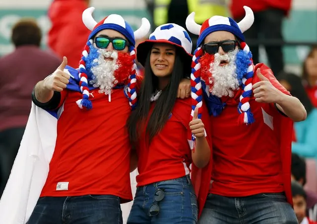 Fans of Chile cheer before their team's 2018 World Cup qualifying soccer match against Brazil at the Nacional Julio Martinez stadium in Santiago, Chile, October 8, 2015. (Photo by Ivan Alvarado/Reuters)