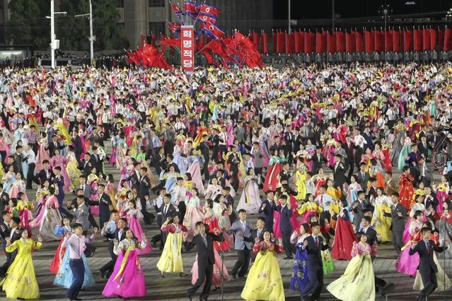 Youth and students attend an evening gala to celebrate the 77th founding anniversary of the Workers' Party of Korea at the Kim Il Sung Square in Pyongyang, North Korea Monday, October 10, 2022. (Photo by Jon Chol Jin/AP Photo)