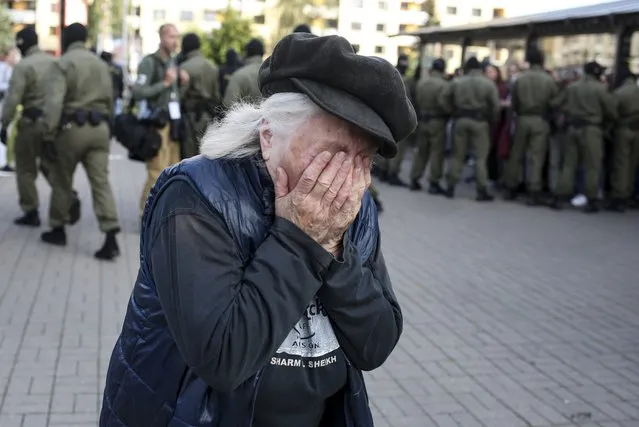An elderly woman reacts as police officers detain women during an opposition rally to protest the official presidential election results in Minsk, Belarus, Saturday, September 19, 2020. (Photo by TUT.by via AP Photo)