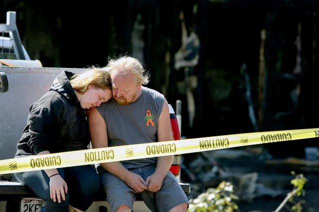 Kelsey Detter, left, embraces her father James Detter outside the scene of a fire in De Soto, Mo., on Sunday, October 11, 2020. Four people killed in an eastern Missouri house fire included a married couple, their daughter and a granddaughter, the victims' family members said. Those killed in the early Sunday fire were Joe Detter, 76, and his wife, Frances Detter, 74, as well as their 37-year-old daughter Sherri Detter and 18-year-old granddaughter Kari Detter, the St. Louis Post-Dispatch reported. (Photo by Christine Tannous/St. Louis Post-Dispatch via AP Photo)