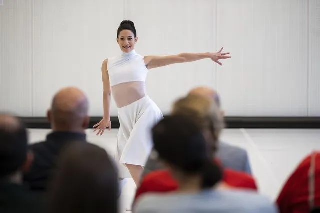 Audi automobile factory workers watch a ballet dancer perform at an open rehearsal at the Audi automobile factory in Gyor, Hungary, Thursday, February 16, 2023. The Ballet Company of Gyor, in Hungary is rehearsing at the Audi automobile factory after being forced to shutter their rehearsal hall in response to soaring energy prices. (Photo by Denes Erdos/AP Photo)