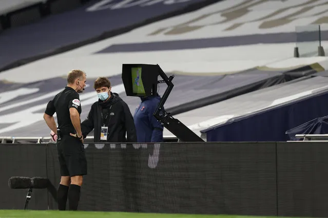 Referee Graham Scott watches the VAR screen as he reviews an incident during the Premier League match between Tottenham Hotspur and Brighton & Hove Albion at Tottenham Hotspur Stadium on November 1, 2020 in London, United Kingdom. Sporting stadiums around the UK remain under strict restrictions due to the Coronavirus Pandemic as Government social distancing laws prohibit fans inside venues resulting in games being played behind closed doors. (Photo by Charlotte Wilson/Offside/Offside via Getty Images)