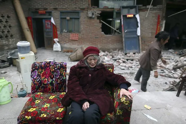 An elderly woman sitting on a sofa in front of damaged houses, cries, after Saturday's earthquake, in Taiping town of Lushan county, Sichuan province April 21, 2013. Rescuers struggled to reach a remote, rural corner of southwestern China on Sunday as the toll of the dead and missing from the country's worst earthquake in three years climbed to 208 with almost 1,000 serious injuries. The 6.6 magnitude quake struck in Lushan county, near the city of Ya'an in the southwestern province of Sichuan, close to where a devastating 7.9 quake hit in May 2008, killing 70,000. (Photo by Reuters/Stringer)