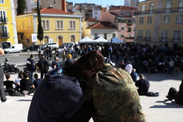 People embrace each other as restaurant owners camp outside the Portuguese Parliament on hunger strike in protest against what they say is insufficient state support for the sector during the coronavirus disease (COVID-19) pandemic in Lisbon, Portugal, December 1, 2020. (Photo by Pedro Nunes/Reuters)