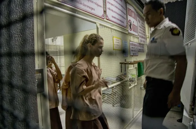 Anastasia Vashukevich, centre, walks into a prison transport vehicle outside a courthouse in Pattaya, south of Bangkok, Thailand, Tuesday, April 17, 2018. Russian s*x guru Alexander Kirillov and about six of his followers, including Vashukevich who claims to have evidence of Moscow's interference in the 2016 U.S presidential election, have emerged briefly for a Thai court hearing after being held virtually incommunicado in an immigration jail. (Photo by Gemunu Amarasinghe/AP Photo)