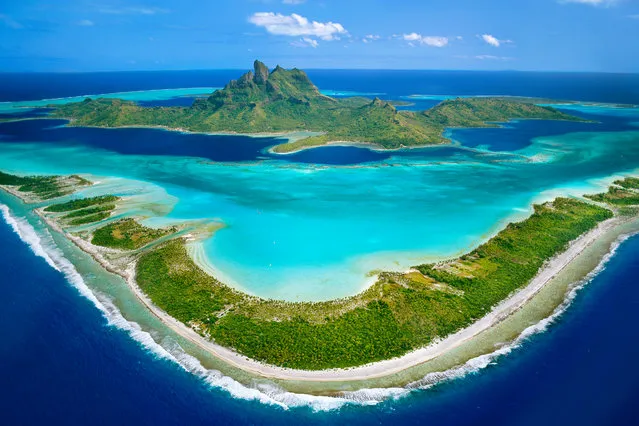 Bora Bora, French Polynesia Pahia and Otemanu. A barrier reef protects the shallow turquoise lagoon surrounding the Pacific islands of Bora Bora, where the extinct volcanic peak of Mount Otemanu juts into the sky. (Photo by Frans Lanting/National Geographic)