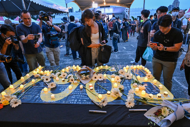 Flowers and candles are seen on a banner during a rally to mark the 35th anniversary of the 1989 Tiananmen Square crackdown, at Liberty Square in Taipei on June 4, 2024. On June 4, 1989, Chinese troops and tanks forcibly dispersed peaceful protests in central Beijing's Tiananmen Square, brutally quelling huge, weeks-long demonstrations in favour of greater political freedoms. (Photo by Song Bilong/The Epoch Times)