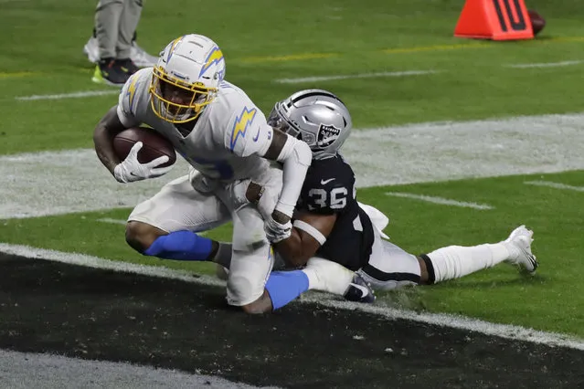 Los Angeles Chargers wide receiver Tyron Johnson (83) scores a touchdown against Las Vegas Raiders' Daryl Worley during the first half of an NFL football game, Thursday, December 17, 2020, in Las Vegas. (Photo by Isaac Brekken/AP Photo)