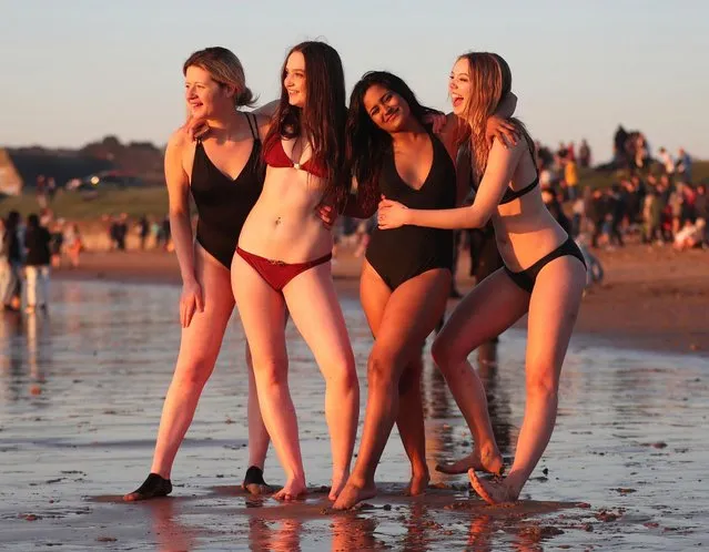 Students from the University of St Andrews take part in the traditional May Day Dip on the East Sands in St Andrews, Fife, Scotland on May 1, 2018. Plunging into the freezing North Sea at dawn on the first of May is said to promote good luck in exams. (Photo by Jane Barlow/PA Images via Getty Images)