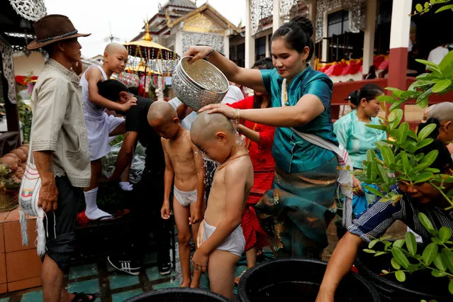Boys are bathed with scented water in preparation for an annual Poy Sang Long celebration, a traditional rite of passage for boys to be initiated as Buddhist novices, in Mae Hong Son, Thailand April 2, 2018. (Photo by Jorge Silva/Reuters)