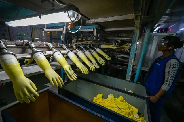 An employee works inside the D.P.L Premier gloves factory in Sri Lanka's Free Trade Zone in Biyagama on February 16, 2023. (Photo by Ishara S. Kodikara/AFP Photo)
