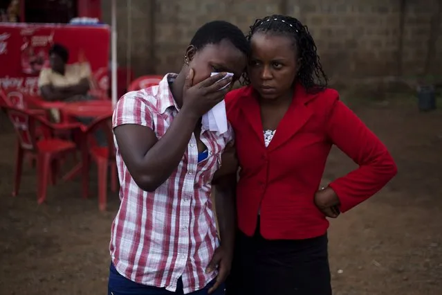 Family members grieve as they wait to collect body of Jackson Mutisya Mula, 28, for burial at the Nairobi city mortuary, Kenya, October 24, 2015. Relatives said that Mula was shot in a street market by an undercover policeman. Many Kenyans complain about how police deal with the public, so crimes often go unreported and relations with officers are strained. Police officials insist the force investigates complaints and reports of corruption, while officers on the ground say they are exposed to violent crime on a regular basis. (Photo by Siegfried Modola/Reuters)