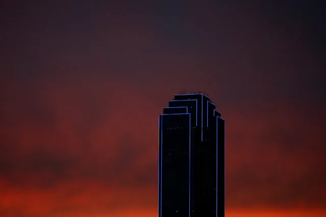 The Bank of America building is lit up in blue, the traditional color of police uniforms as a tribute following the multiple police shootings in Dallas, Texas, U.S., July 9, 2016. (Photo by Carlo Allegri/Reuters)