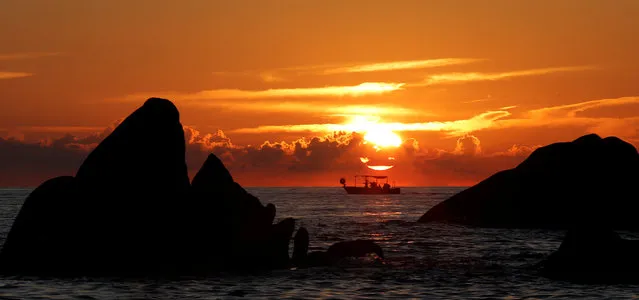 A small fisherman's boat makes its way past the rocks of Sete Nave as the sun sets outside Pietrosella, on the southern part of Corsica, France, September 22, 2016. (Photo by Christian Hartmann/Reuters)