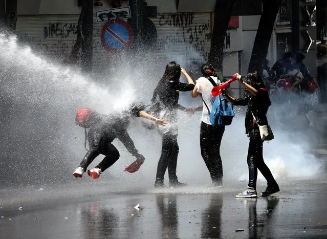 Turkish protesters clash with riot police during a rally supporting Istanbul demonstrations against the conservative government of Prime Minister Recep Tayyip Erdogan, in Ankara, Turkey, 07 June 2013. (Photo by Muammer Tan/EPA)