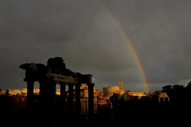 This photograph taken in Rome on February 27, 2023, shows the rainbow above the Roman Forum and the Colosseum. (Photo by Vincenzo Pinto/AFP Phoot)