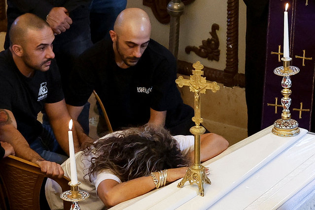 A woman reacts as mourners attend the funeral for Shimon Najm, a Lebanese-born former soldier in the South Lebanon Army who became an Israeli citizen following Israel's withdrawal from Lebanon in 2000, and who was killed on Tuesday by a Hezbollah rocket attack, in a church in Mi'ilya, a Christian-majority village in northern Israel on November 14, 2024. (Photo by Thomas Peter/Reuters)