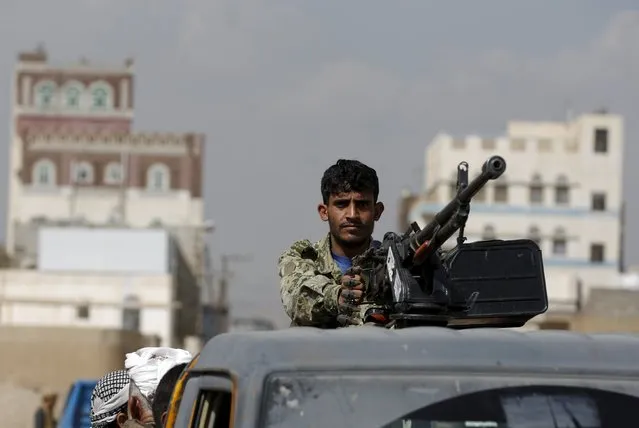A Houthi militant holds a machine gun mounted on a patrol truck securing the site of a gathering held by tribesmen loyal to the Houthi movement to show their support for the group, in Yemen's capital Sanaa December 15, 2015. (Photo by Khaled Abdullah/Reuters)