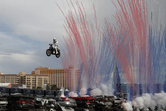 Travis Pastrana jumps a row of crushed cars on a motorcycle, Sunday, July 8, 2018, in Las Vegas. (Photo by John Locher/AP Photo)