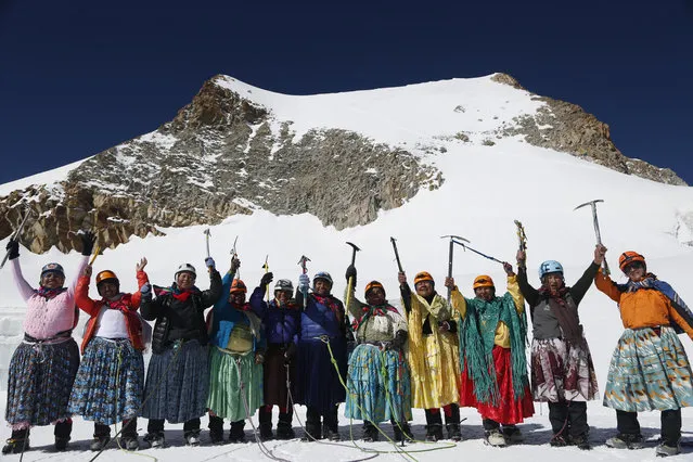 In this December 16, 2015 photo, Aymara indigenous women pose for a picture as they reach the peak of the Huayna Potosi mountain on the outskirts of El Alto, Bolivia. From left are Cecilia Llusco, Juana Rufina Llusco Alana, Janet Mamani Callisaya, Domitila Alana Llusco, Marga Alana Llusco, Virginia Quispe Colque, Pacesa Llusco Alana, Lidia Huayllas, Bertha Vetia, Dora Magueno and Ana Gonzales. (Photo by Juan Karita/AP Photo)
