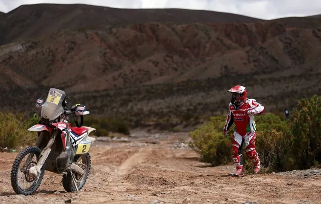 Paulo Goncalves of Portugal walks towards his Honda motorcycle at the end of the fourth stage in the Dakar Rally 2016 in Jujuy province, Argentina, January 6, 2016. (Photo by Marcos Brindicci/Reuters)