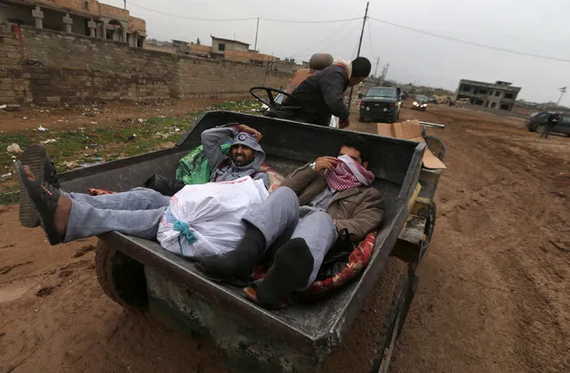 Iraqi people ride in a vehicle as they flee the Islamic State stronghold of Mosul in al-Samah neighborhood, Iraq December 1, 2016. (Photo by Mohammed Salem/Reuters)