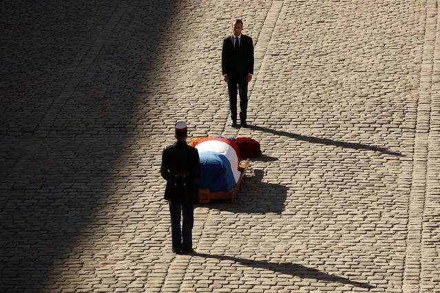 French President Emmanuel Macron stands behind the coffin of Charles Aznavour during a ceremony to pay a tribute to late singer Charles Aznavour in Paris, France, 05 October 2018. Aznavour, the French crooner and actor whose performing career spanned eight decades and who seduced fans around the world with his versatile tenor, lush lyrics and kinetic stage presence, has died on 01 October at the age of 94. (Photo by Yoan Valat/EPA/EFE)