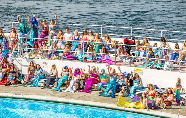 Mermaids gather at the Plymouth Lido in Devon on June 2, 2022, as they attempt to break a world record for the biggest mermaid gathering. (Photo by South West News Service)
