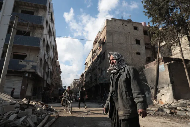Syrian Abu Khaled looks at the rubble of his destroyed house in the rebel-held town of Douma, on the eastern outskirts of Damascus, on December 30, 2016, on the first day of a nationwide truce. Clashes erupted between Syrian government forces and opposition fighters in an area outside Damascus, despite a nationwide truce that began at midnight, a monitor said. (Photo by Abd Doumany/AFP Photo)