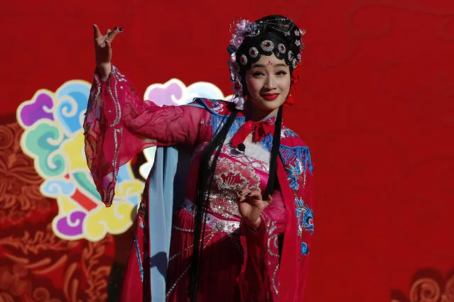 A Chinese performer dressed in traditional costume performs a cultural dance during a temple fair for a Lunar New Year celebration in Beijing, Monday, February 8, 2016. (Photo by Andy Wong/AP Photo)