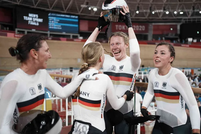 Team Germany celebrates after winning the gold medal and setting a world record competes during the track cycling women's team pursuit at the 2020 Summer Olympics, Tuesday, August 3, 2021, in Izu, Japan. (Photo by Thibault Camus/AP Photo)
