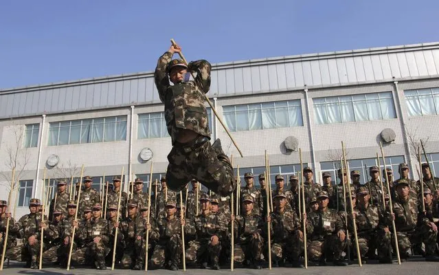 A newly recruited paramilitary policeman participates in a drill in Hohhot, Inner Mongolia autonomous region on December 2, 2013. (Photo by Reuters/China Daily)