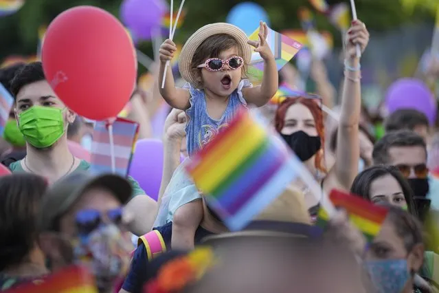 A child cheers during the gay pride march in Bucharest, Romania, Saturday, August 14, 2021. (Photo by Vadim Ghirda/AP Photo)