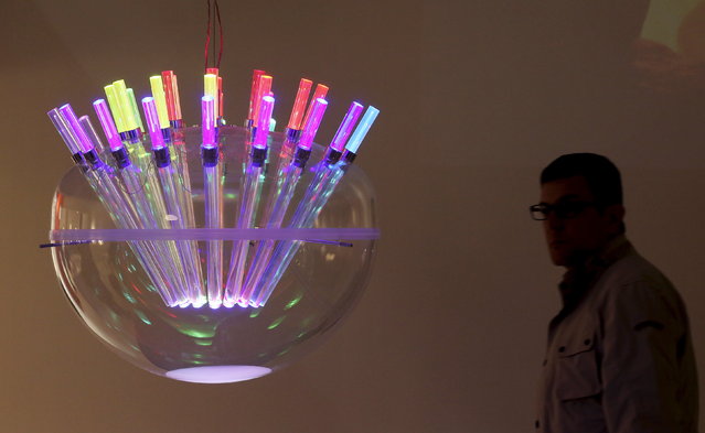 A visitor looks at a creation at the Artemide space during Milan Design Week, April 14, 2015. (Photo by Stefano Rellandini/Reuters)