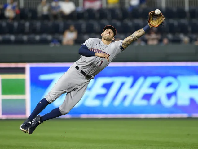 Houston Astros shortstop Carlos Correa can’t quite reach this single off the bat of Kansas City Royals’ Andrew Benintendi during the fourth inning of a baseball game Tuesday, August 17, 2021, in Kansas City, Mo. (Photo by Reed Hoffmann/AP Photo)
